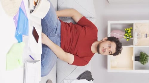 Young Adult on Couch with Phone and Book
