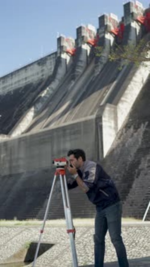 Blue collar worker is working at the dam.