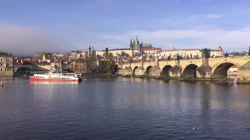 Vltava river, Prague Castle, Charles Bridge and cruise ship in Czech Republic in autumn weather