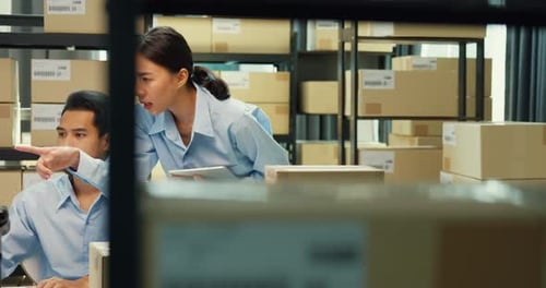 Workers in Office at Computer and Boxes