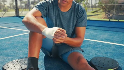 Paddle tennis, injury and bandage on hand for first aid, healing and health on court outdoor