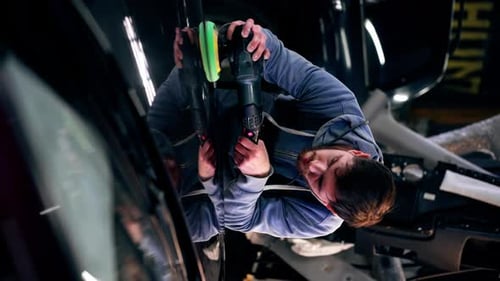 Vertical Video the Car Mechanic at a Service Station Doing the Final Polishing to Shine
