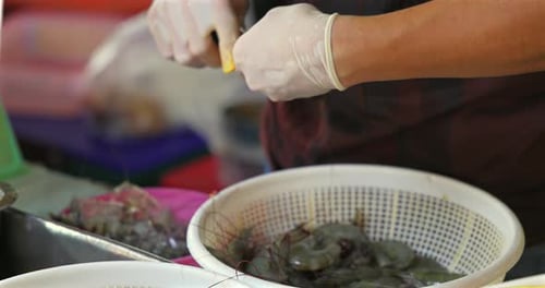 Gloved Person Peeling Fresh Shrimp