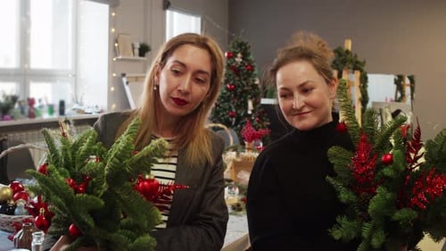Women at Workshop on Creating Compositions From Branches Hold Bouquets of Fir Branches in Hands and