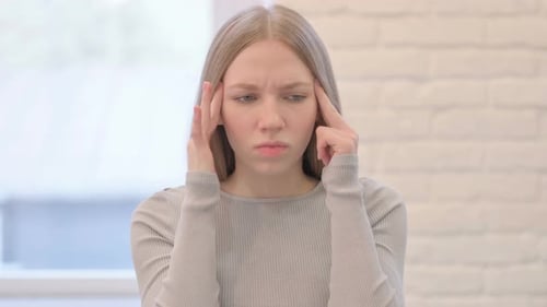 Young Adult Woman Experiencing a Headache