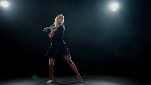 Blonde Woman Dancing Contemporary in Dark Studio
