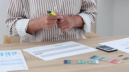 Business planning. Woman with calendar at wooden table in office, closeup