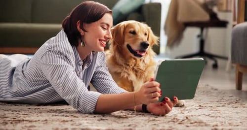 Woman and Dog Looking at Tablet Together