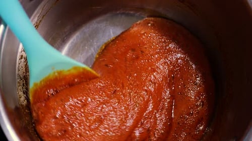 Thick Red Sauce Being Stirred in Metal Pot