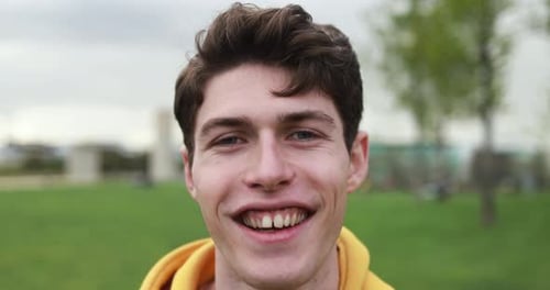 Smiling young man looks confidently at the camera on summer vacation in the USA