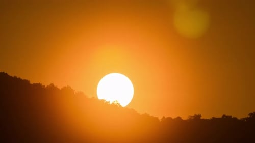 Breathtaking beauty of the sun rising time lapse video over a rugged mountain ridge on a cloudy morn