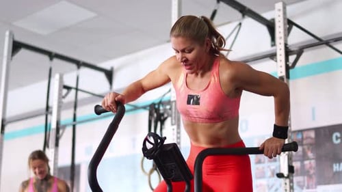 Determined Athlete Intensely Exercising on Assault Bike
