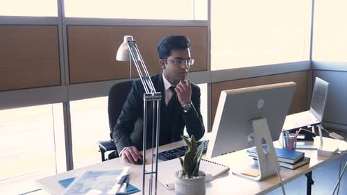 Focused Businessman Working at Office Desk