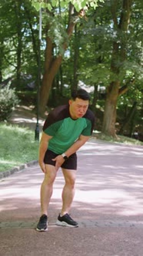 Japanese Runner Athlete Man with Muscle Pain in Park Trauma Injury While Jogging Leg Muscle Cramp