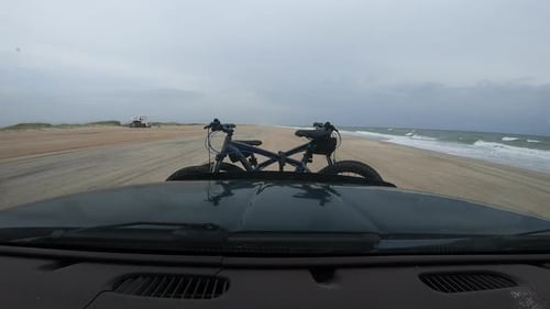 Dashboard Hyperlapse of an adventure seeking couple traveling along a shoreline and turning off into