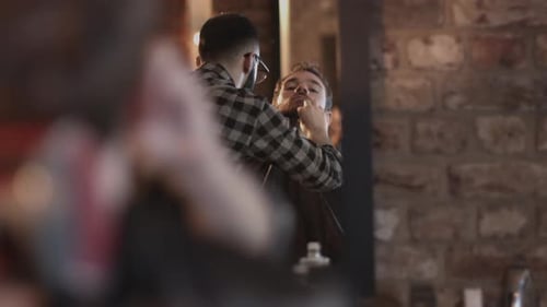 Man getting beard trim at a barber shop
