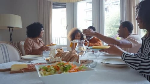Happy Family Sharing Meal Together at Home