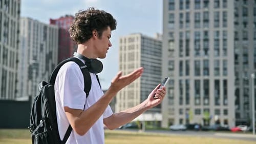Young Handsome Man Having Video Call Chat on Smartphone Outdoor City Background