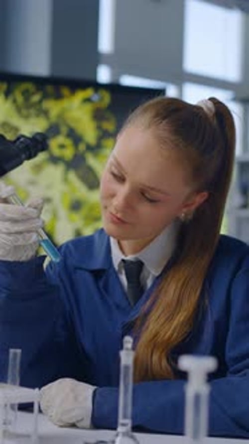 Female Scientist Works with Test Tubes in Lab