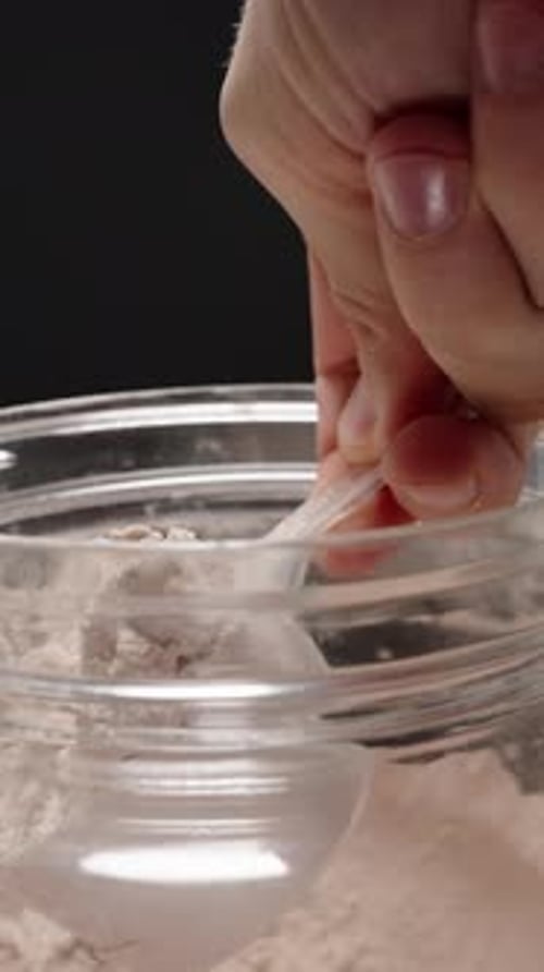 Scooping Chocolate Protein Powder From Jar