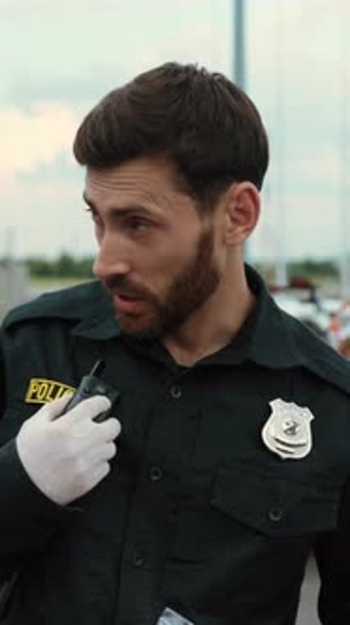 Confident Police Officer Communicates on Radio in City