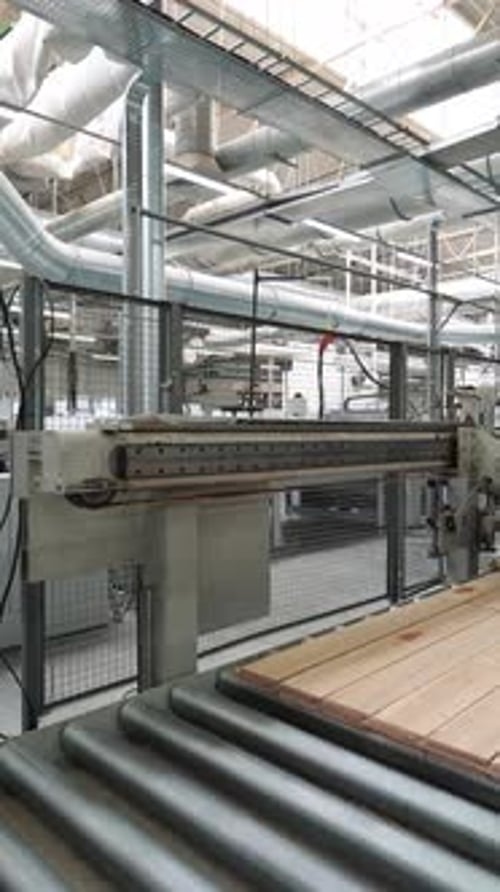 automatic conveyor makes many pieces of parquet board move fast in manufacturing plant