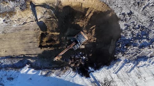 Excavator Digging Hill Drone Aerial Rising Reveal Snowy Landscape Construction Site
