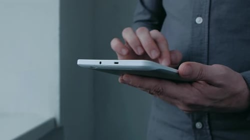 Adult Using Tablet Device Indoors