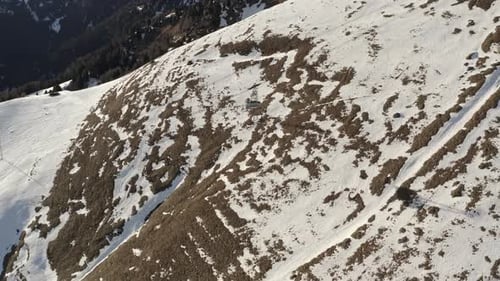 Funicular Chairlift lifts skiers and snowboarders, Alp mountains, Aerial