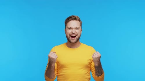 Expressive Young Man Over Vibrant Background Studio Portrait of Handsome Person