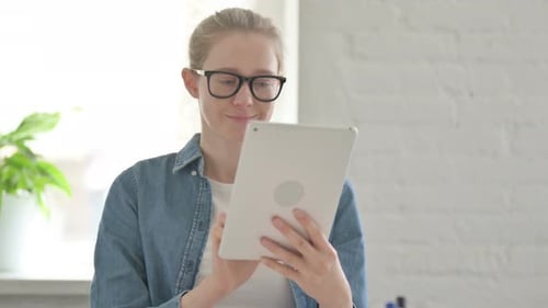 Blonde Woman Using Tablet Indoors During the Day