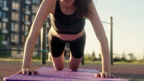 Woman Exercising Outdoors Doing Push-Ups