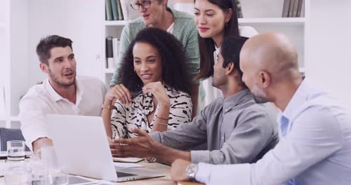 4k video footage of a group of businesspeople using a laptop in a modern office
