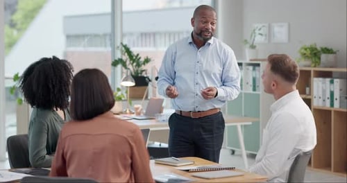 Business, man or speaker with team for presentation, meeting or training in office with feedback