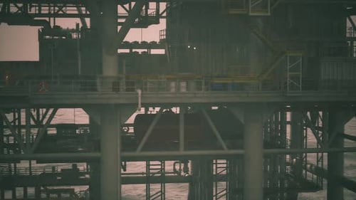 Oil Rig Structure in the Ocean During a Cloudy Sunset