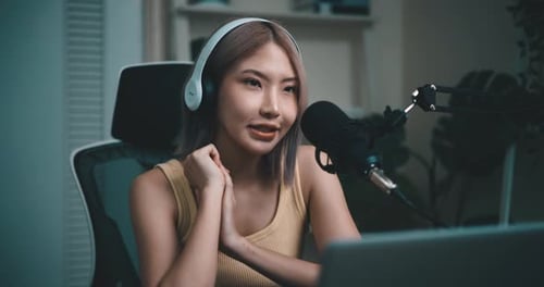 Woman Speaking into Microphone Recording Podcast