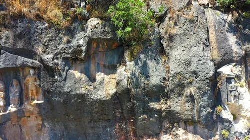 Ancient Stone Cliff with Carved Reliefs