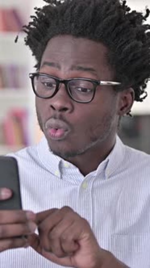 Man Reacting to Good News on Smartphone