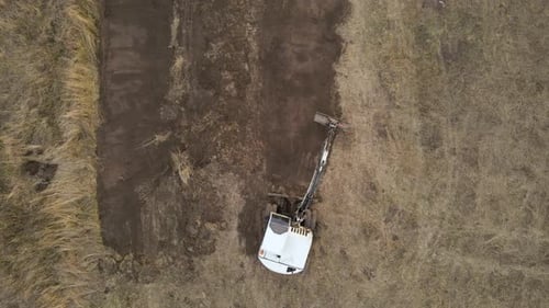 Earth Moving Tractor Preparing Place for Future House Foundation Construction