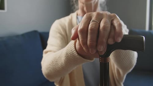 Close-Up of Hands of Elderly Woman on Walking Cane