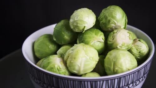Bowl of Fresh Green Brussels Sprouts Close Up