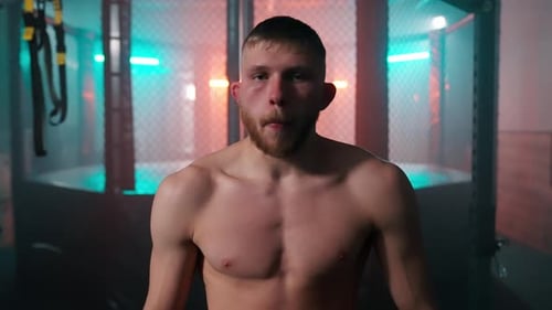 Shirtless Fighter Breathing Heavily After Workout