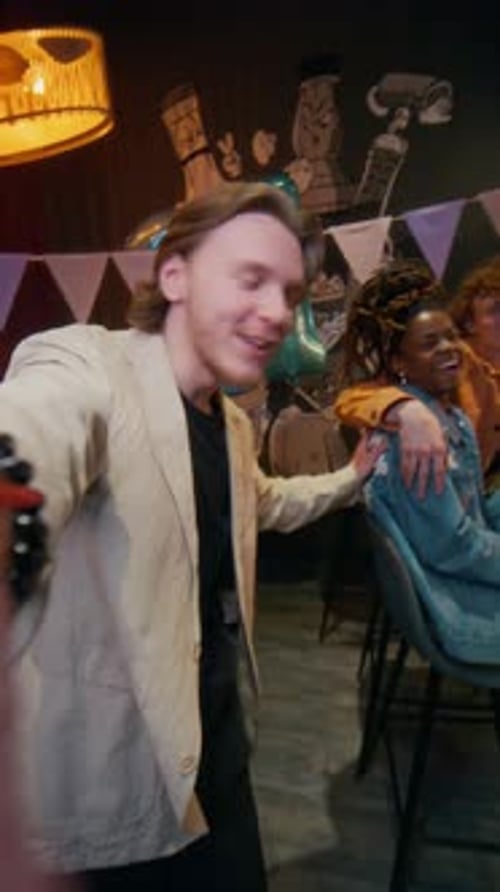 Portrait of Man Recording Dancing with his Friends at Birthday Party in Bar