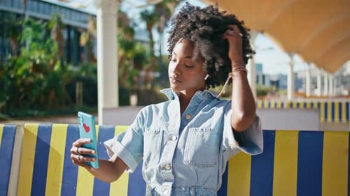 Stylish Woman Takes Selfie in Urban Setting