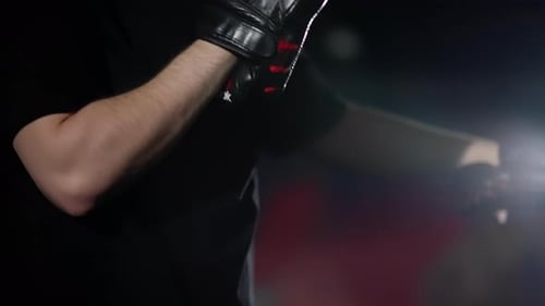 Female Athlete Kicking Pads in Boxing Gym with Trainer