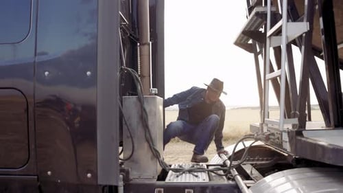 Male Farmer Inspecting Semitruck Trailer on Farm 10 Seconds or Greater