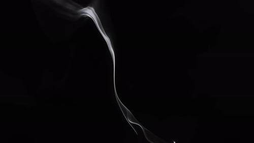 Wispy smoke flowing gently on a dark background