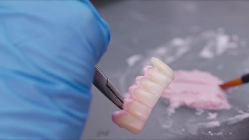 Dental Technician Creating Dental Bridge Close Up