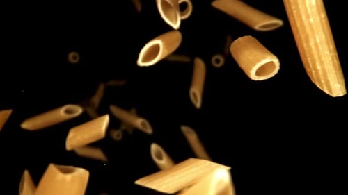 Penne Pasta Floating on a Black Background