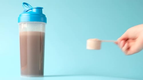 Protein Powder and Shake on Blue Background